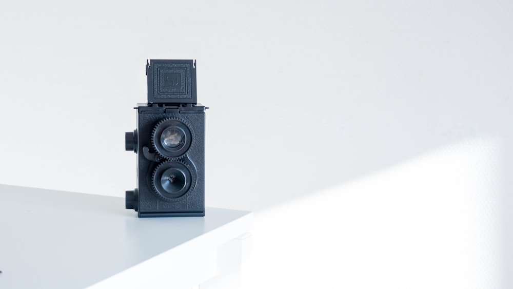 a small camera sitting on top of a white table