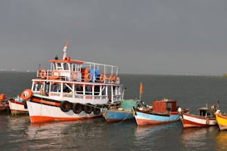 white and red boat on sea during daytime