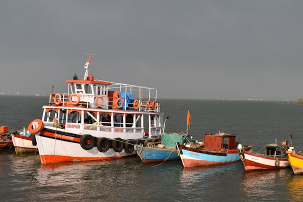 white and red boat on sea during daytime