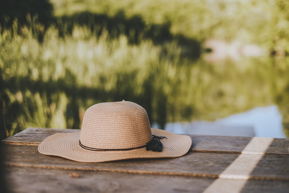 brown fedora hat on brown wooden table