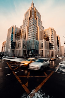 cars on road near high rise buildings during daytime