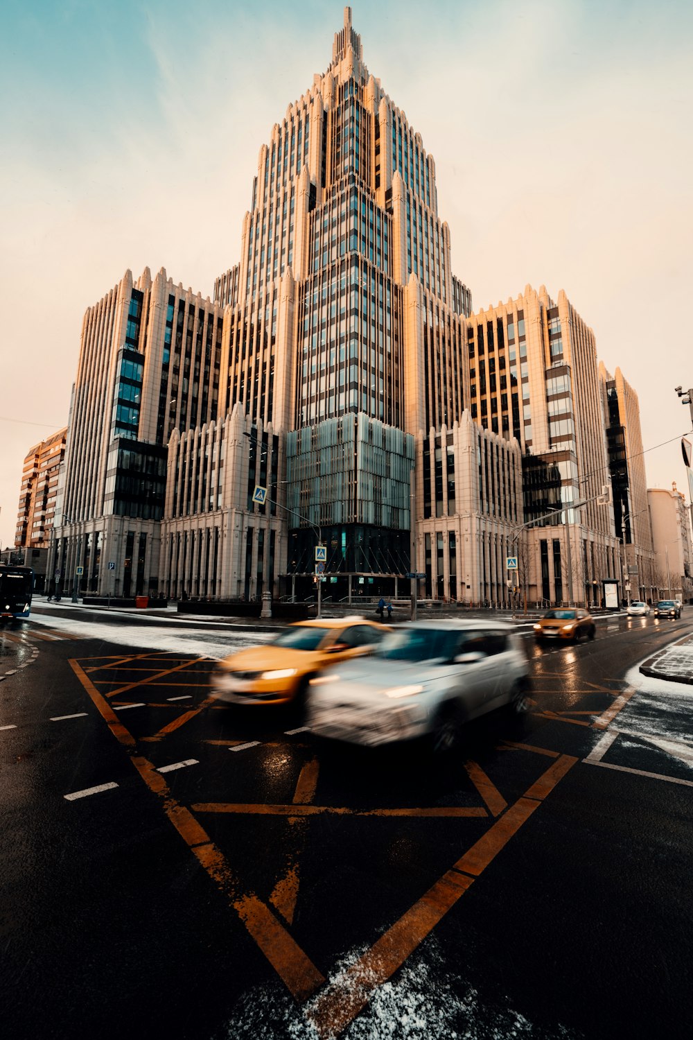 cars on road near high rise buildings during daytime