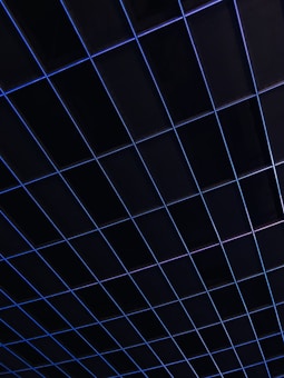 A grid of dark squares intersected by thin blue lines, creating a geometric pattern. The overall appearance suggests a structured and modern design.