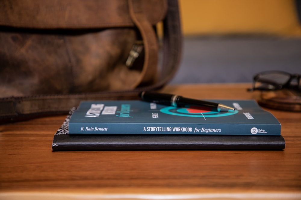 black and red book on brown wooden table