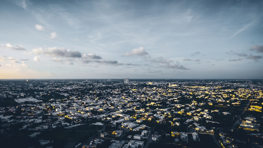 city buildings under white clouds during daytime