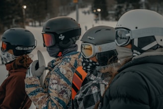 2 men in black and white jacket wearing helmet during daytime