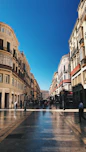 people walking on street between buildings during daytime
