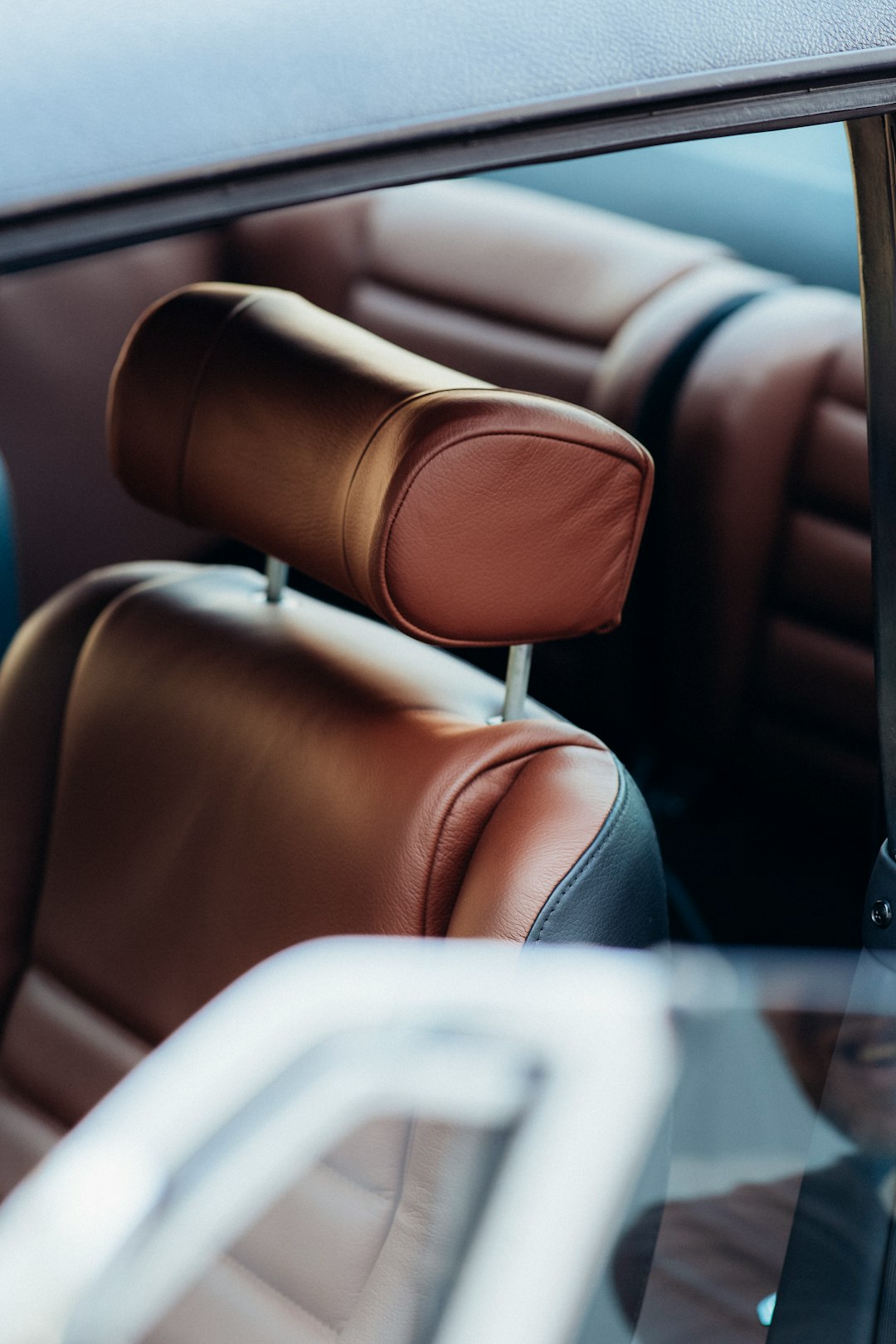 brown leather car seat with white textile