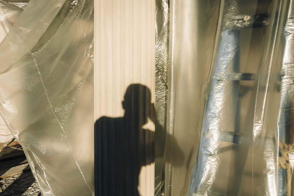 woman in black dress standing in front of glass window