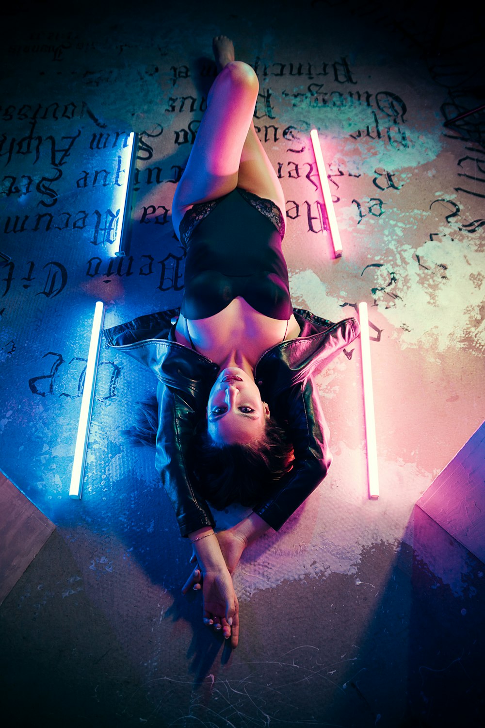 woman in black lingerie standing on gray concrete floor