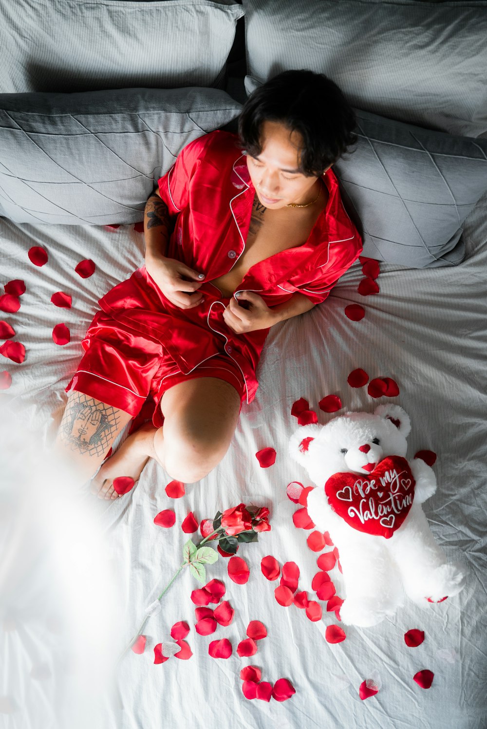 woman in red shirt lying on bed