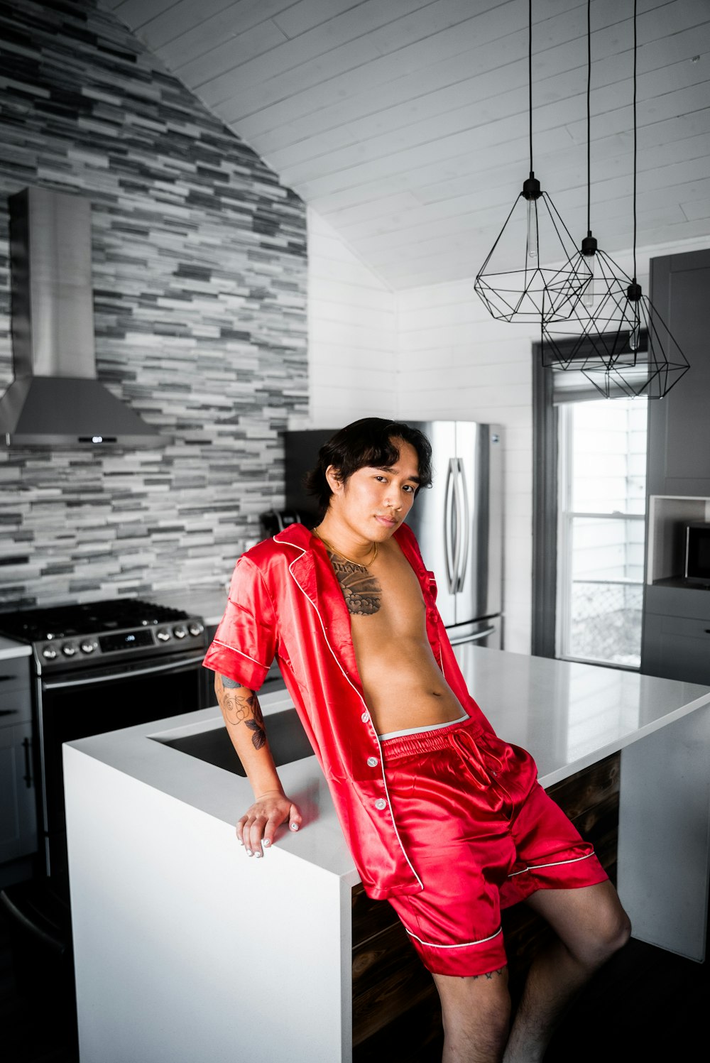 woman in red dress standing near kitchen sink