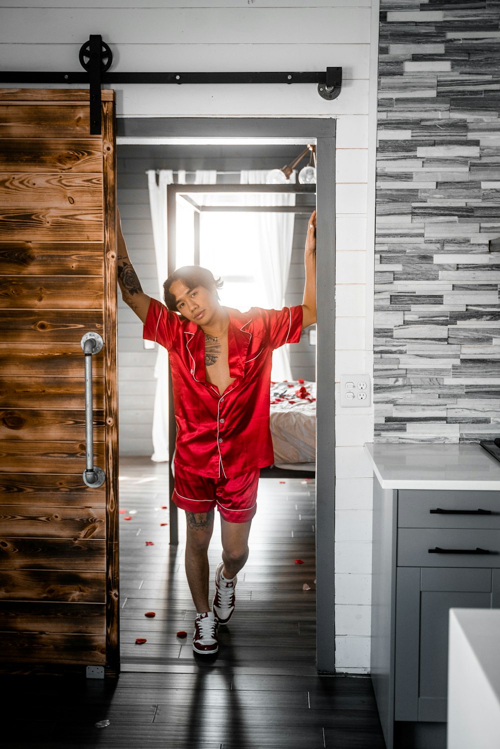 woman in red t-shirt and red pants standing on brown wooden parquet floor