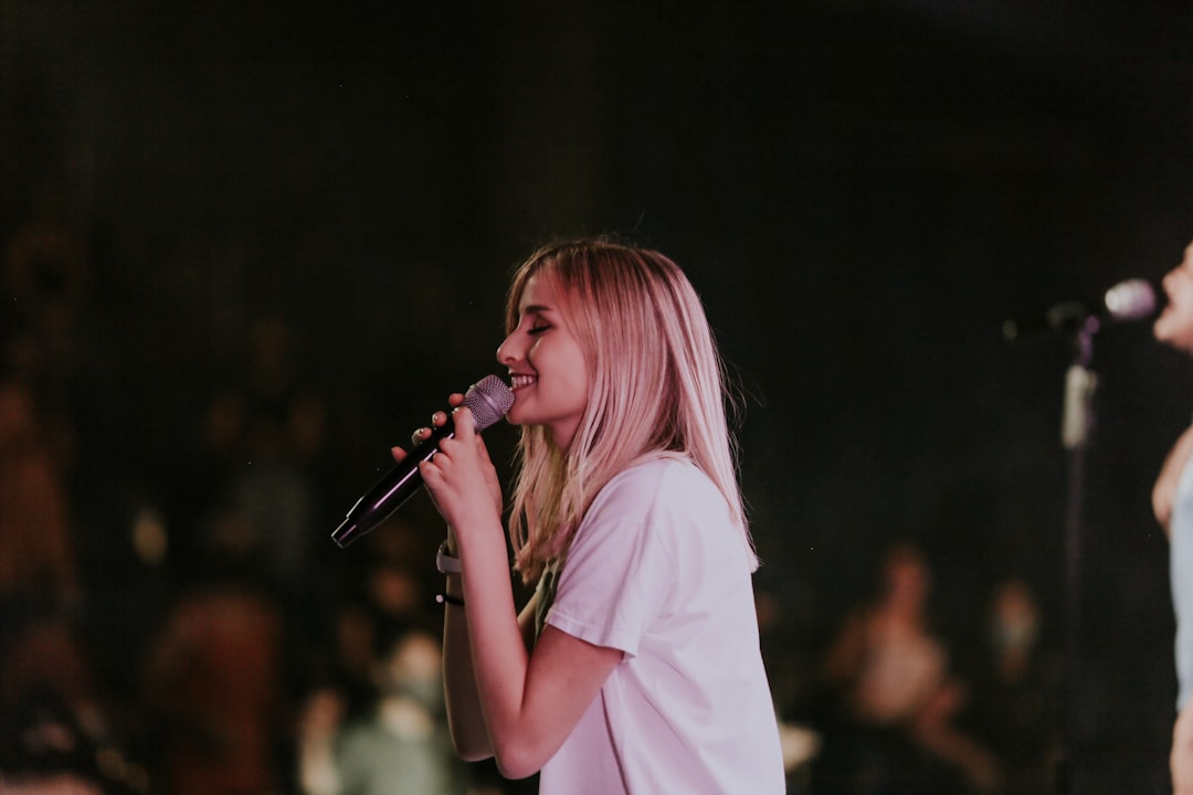 woman in white t-shirt singing