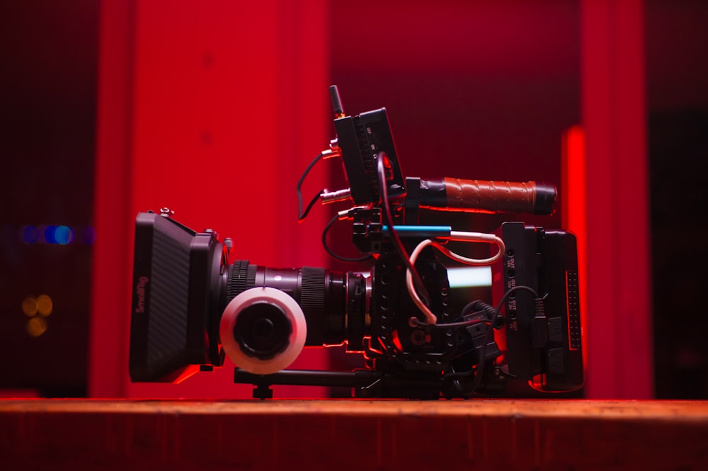 black and gray dslr camera on brown wooden shelf