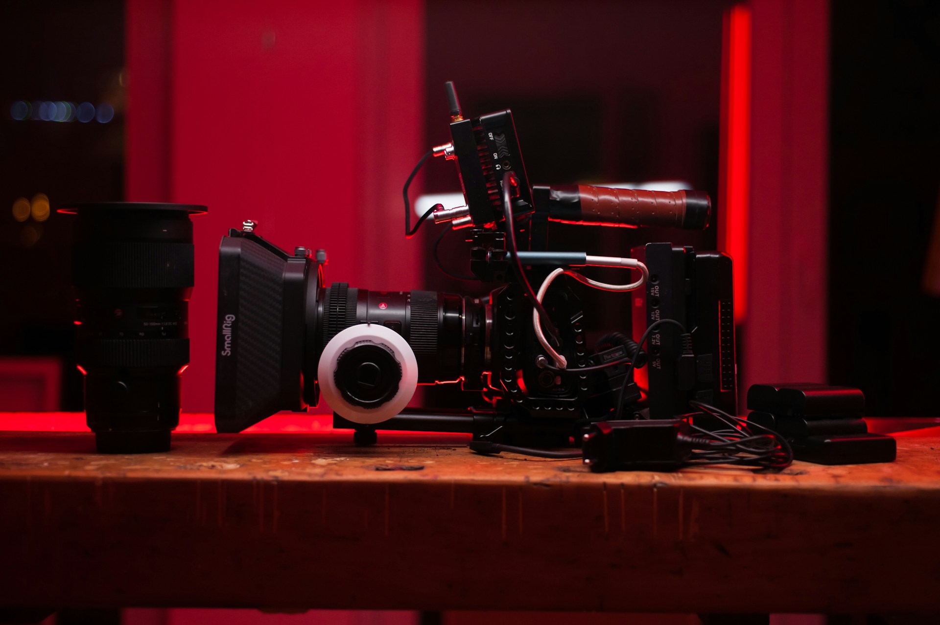 black and red video camera on brown wooden table