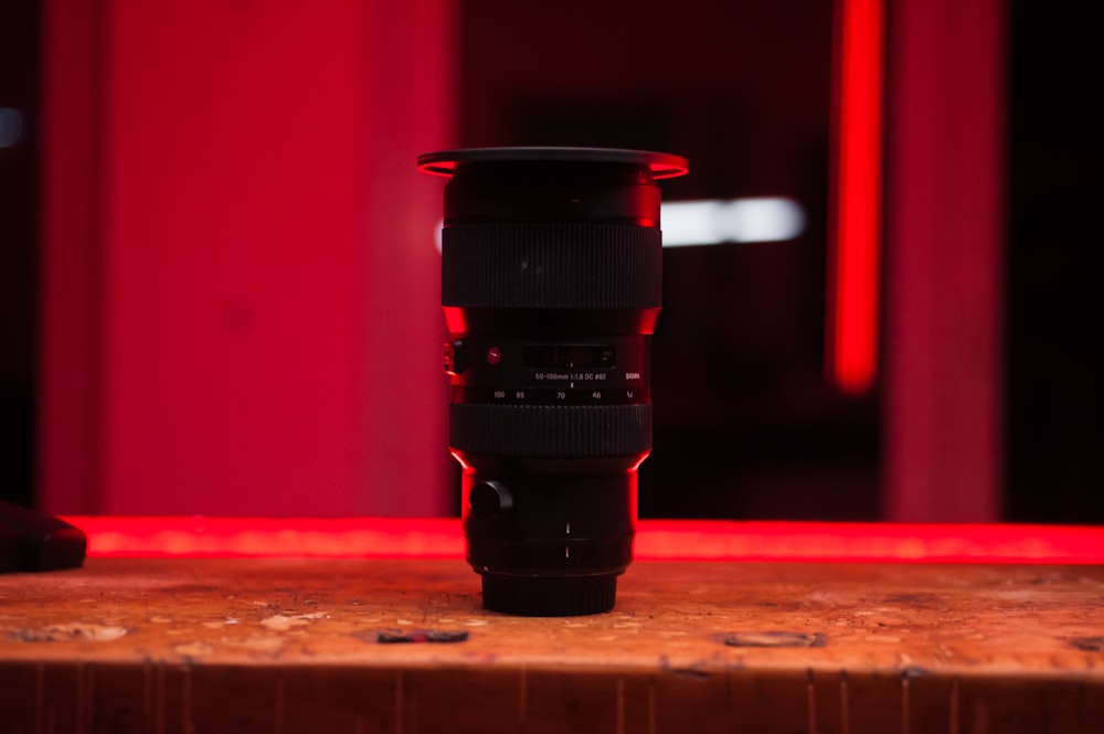 black camera lens on brown wooden table