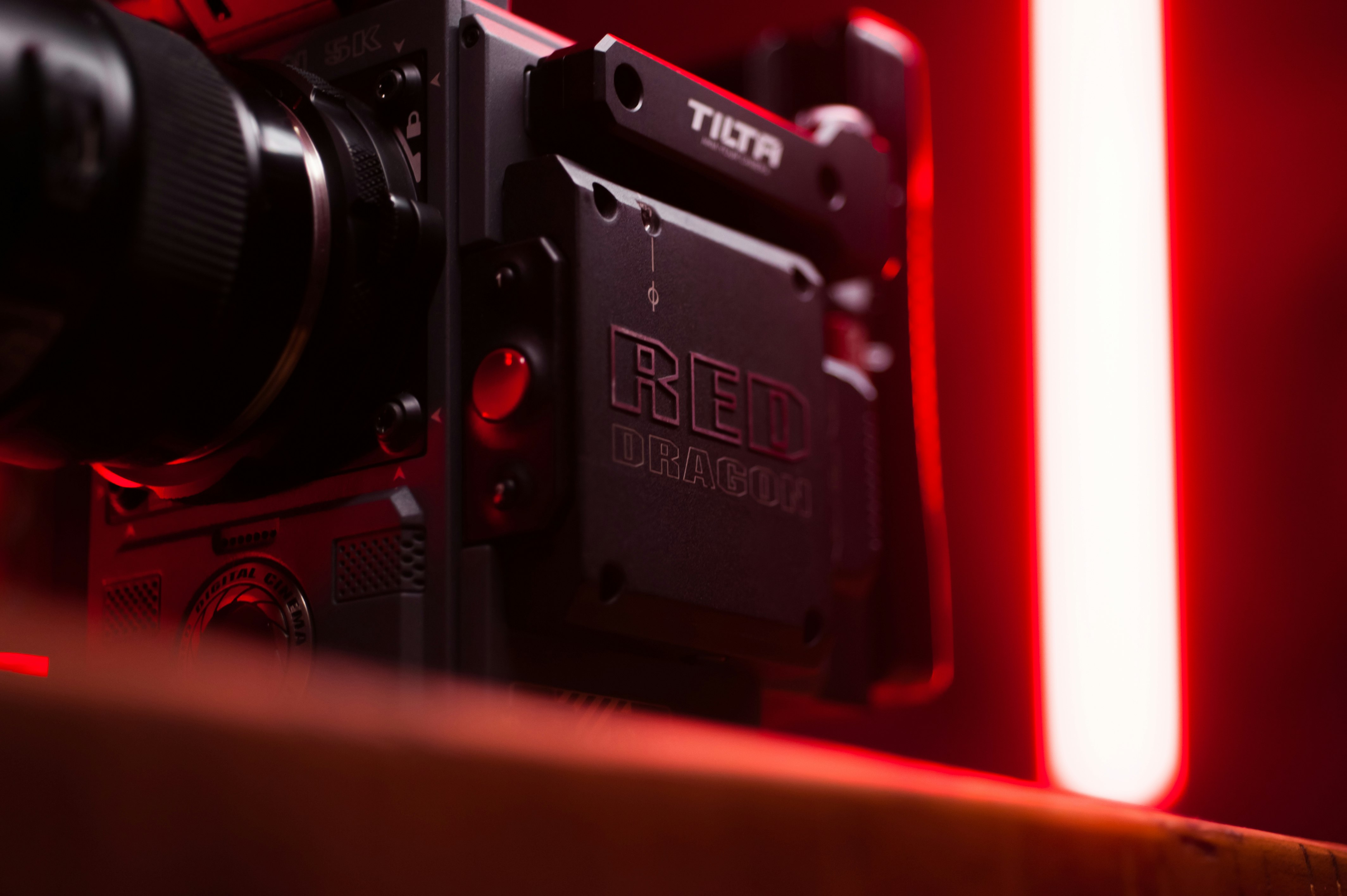 black and red camera on brown wooden table