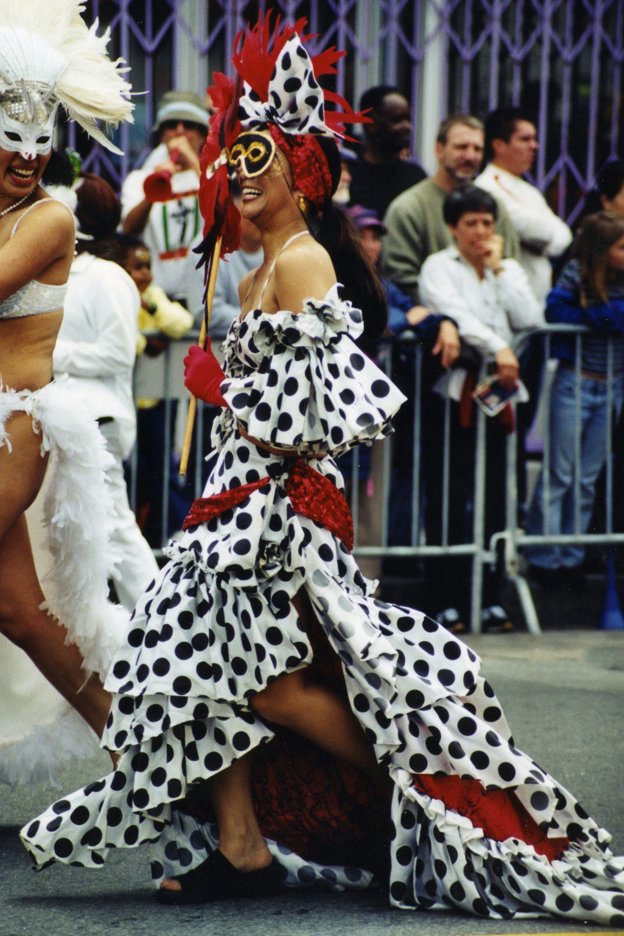 woman in white and black polka dot dress wearing white fur hat