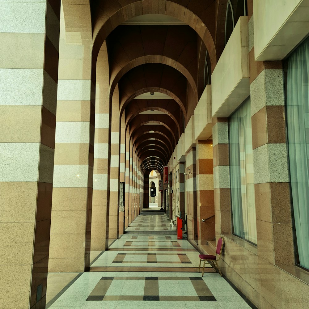 person in red jacket walking on hallway