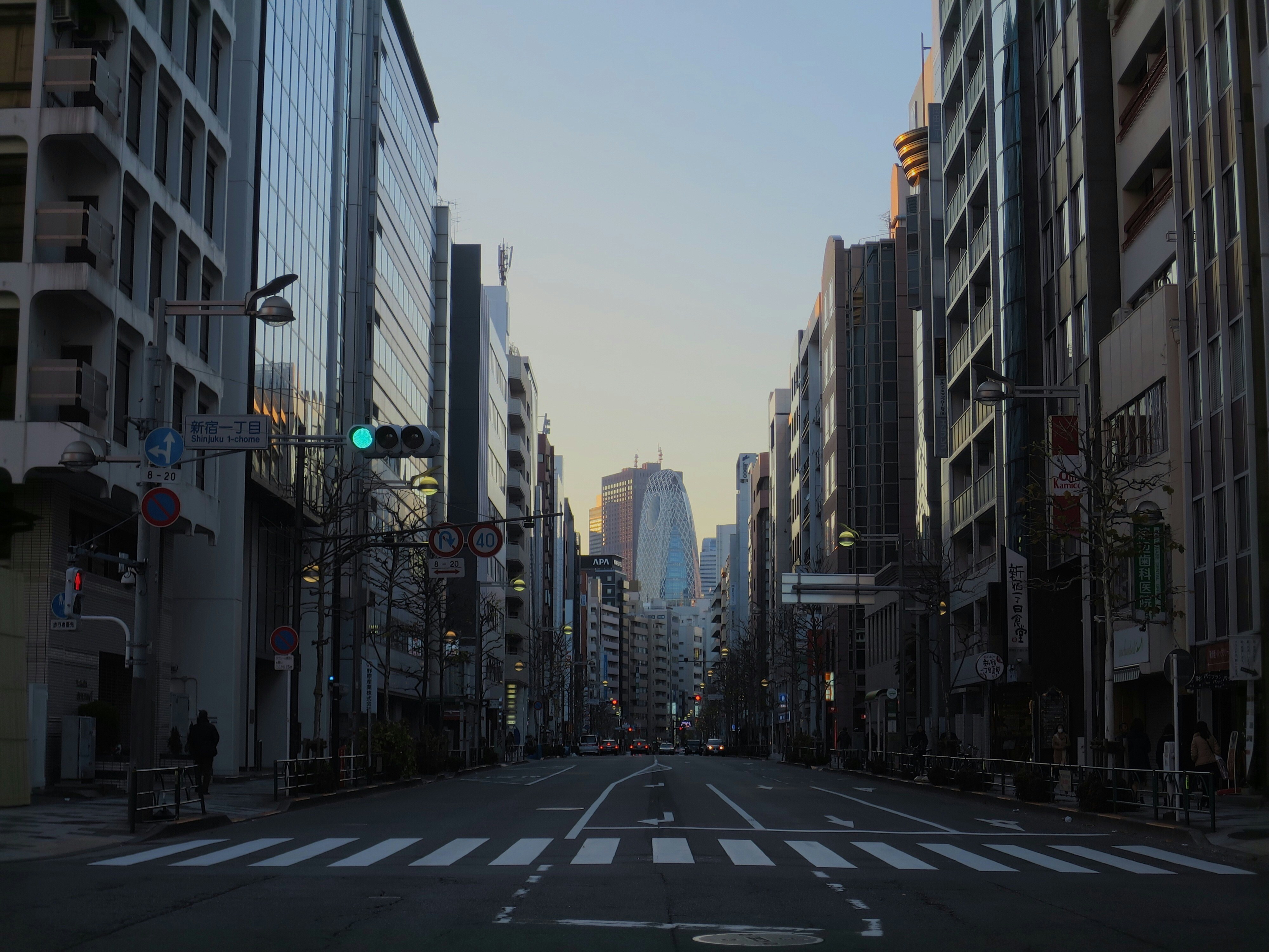 gray concrete road between high rise buildings during daytime, 新宿一丁目交差点 / Intersection at Shinjuku 1-chome