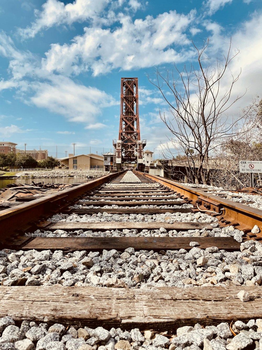 brown metal train rail under blue sky during daytime