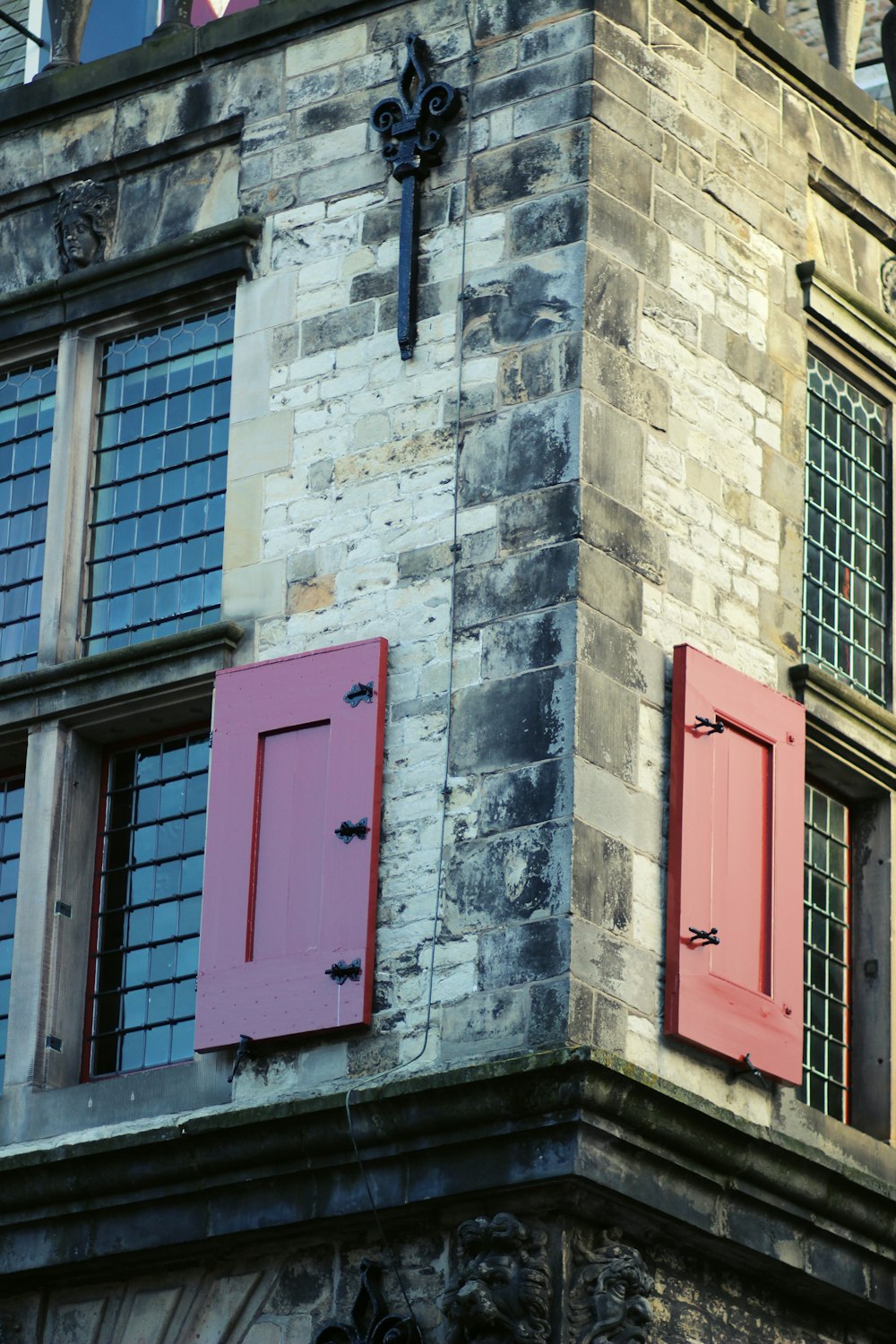 red wooden door on gray concrete building