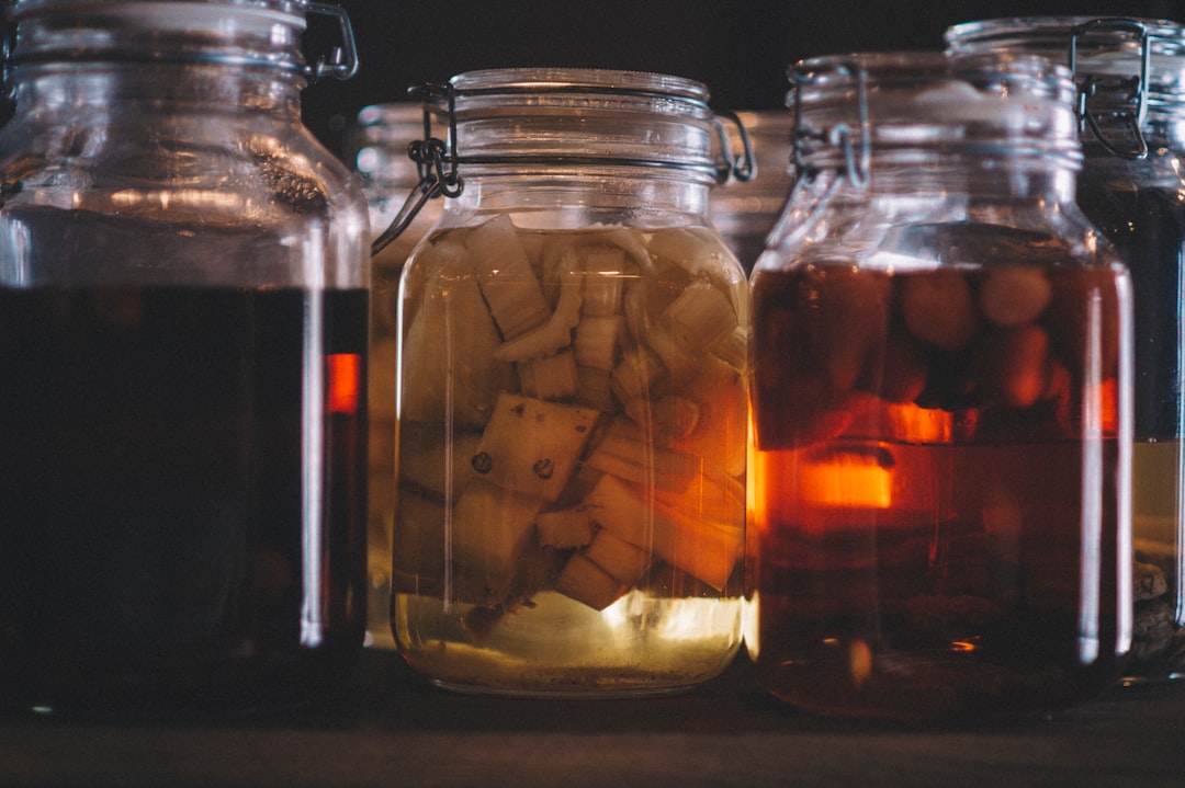 clear glass jar with brown liquid inside