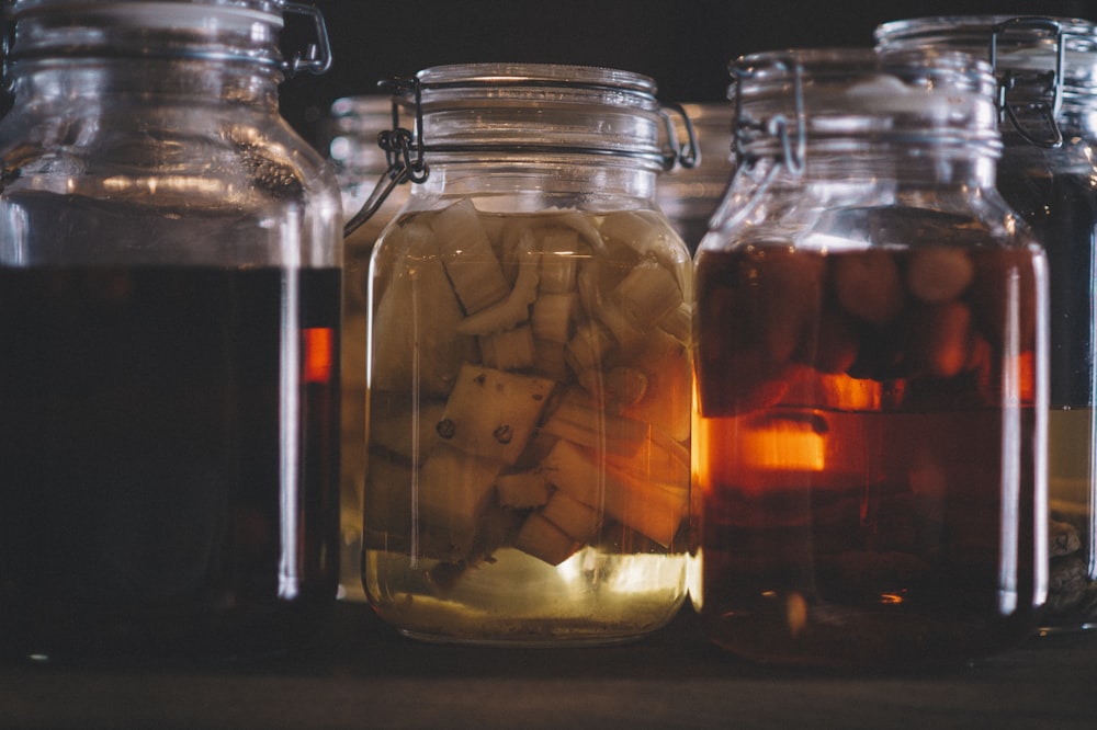 clear glass jar with brown liquid inside