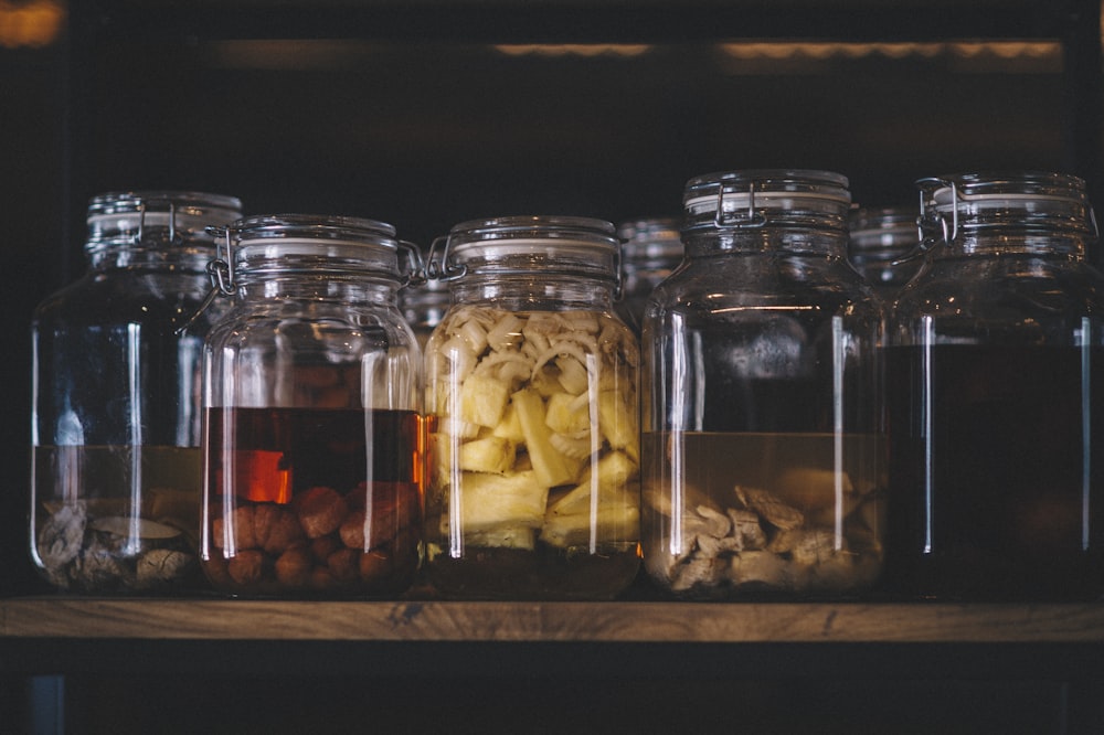 clear glass jars with brown and white stones