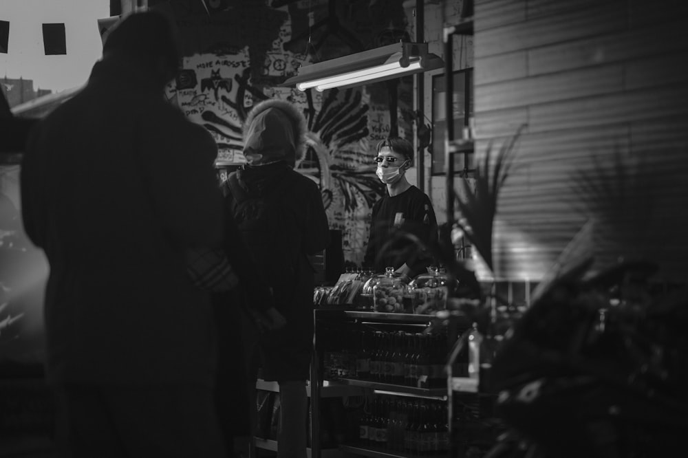 grayscale photo of people in store