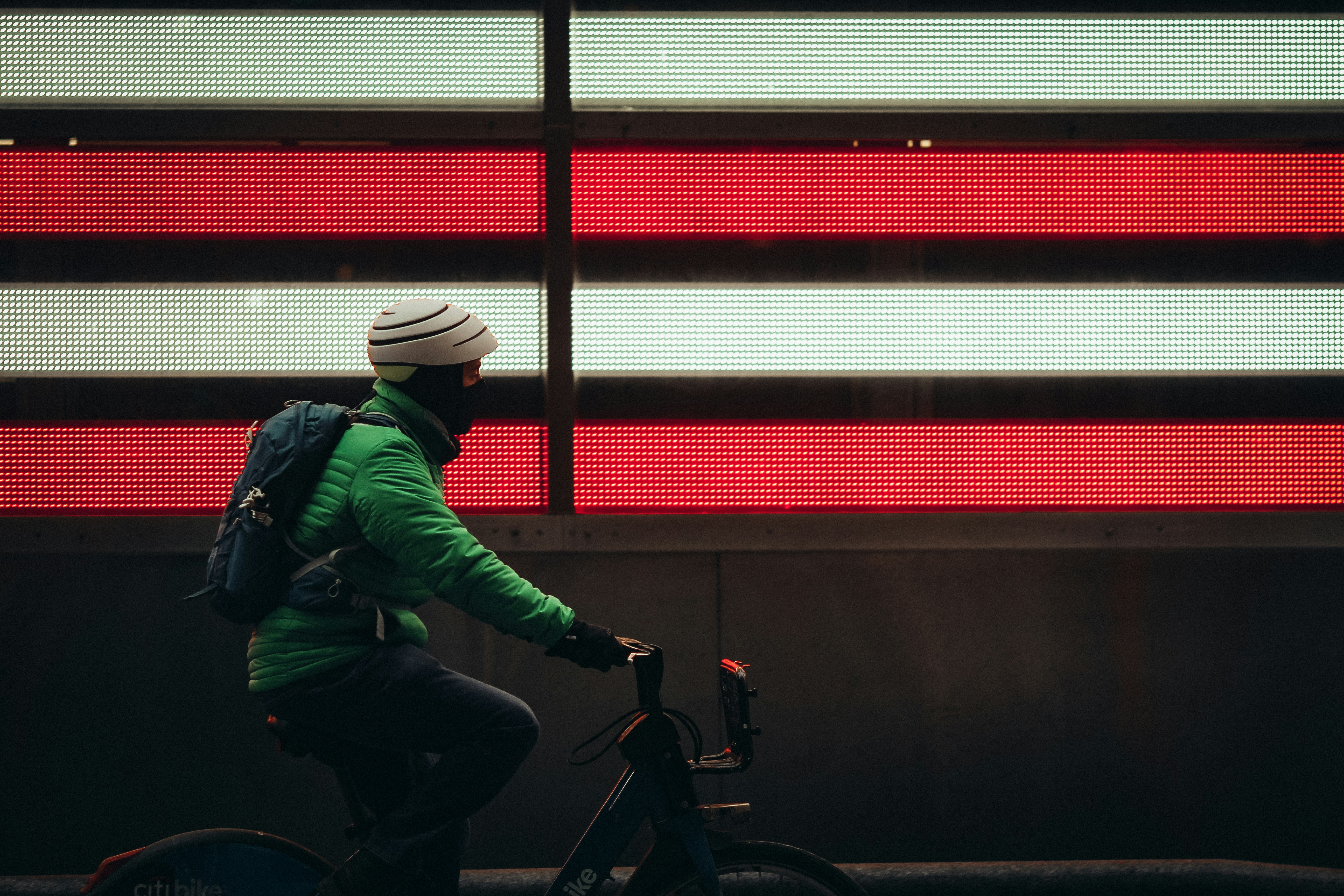man in green jacket riding motorcycle