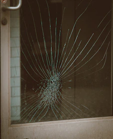 Before and after shot of a storefront glass repair completed by smartfix glass and door service inc. in St. Petersburg.