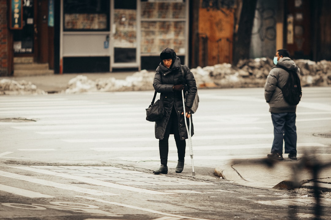 woman in black jacket and black pants walking on snow covered ground during daytime