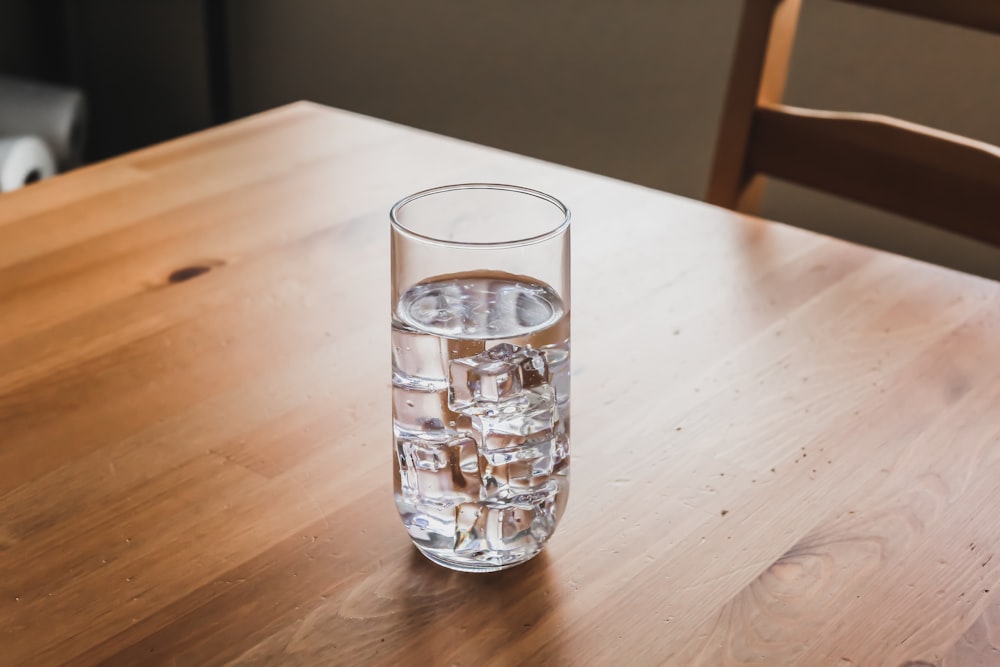 clear drinking glass on brown wooden table