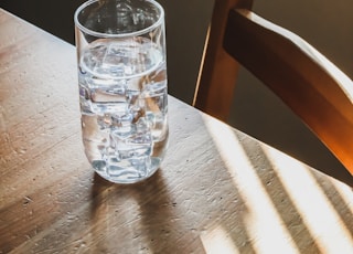 clear drinking glass on brown wooden table