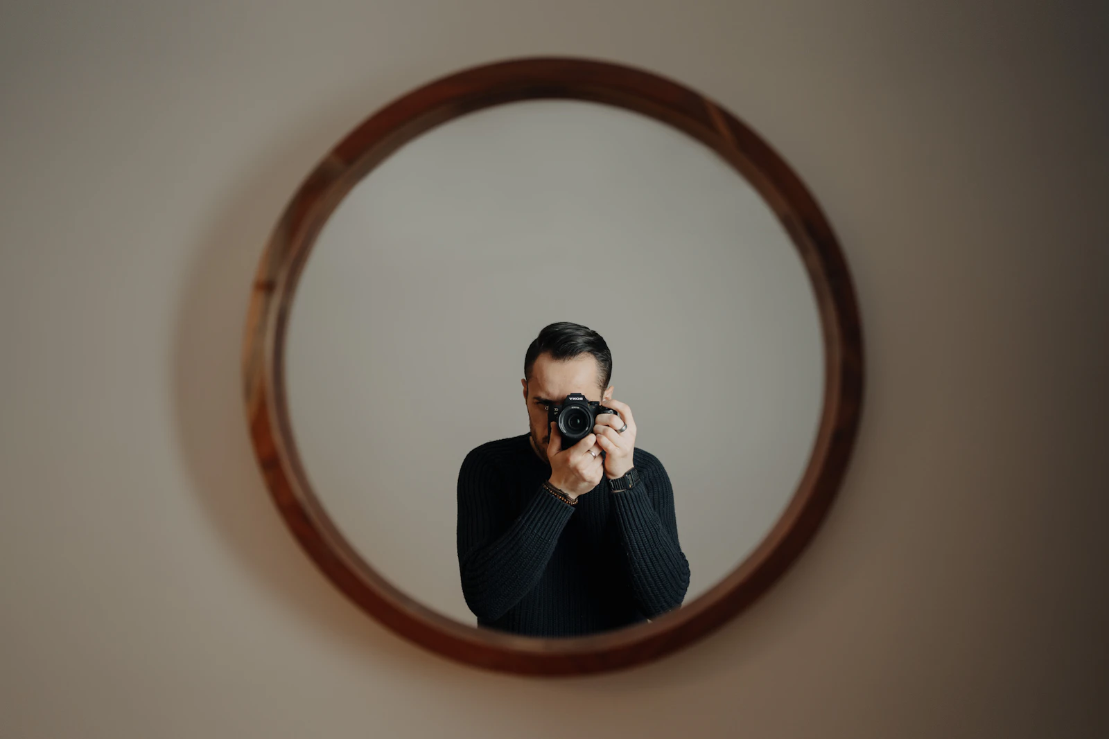 A man getting ready, looking in a mirror