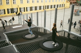 woman in black jacket and black pants standing on round black metal table