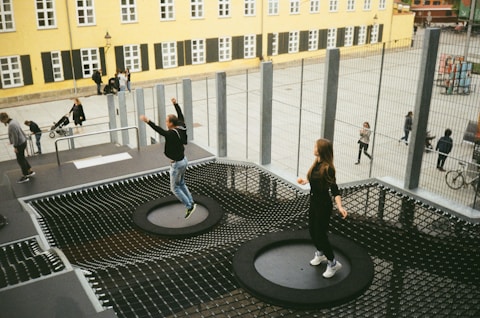 woman in black jacket and black pants standing on round black metal table