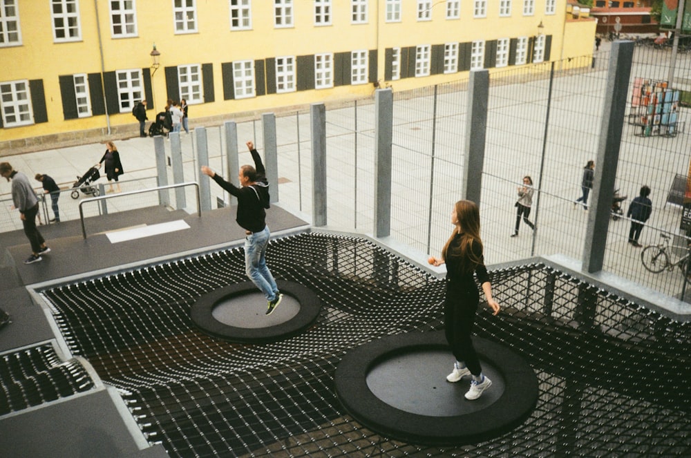 woman in black jacket and black pants standing on round black metal table