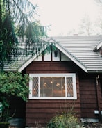 brown wooden house with green plants