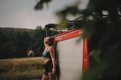 Runner cooling down with foam rolling to aid muscle recovery outdoors.
