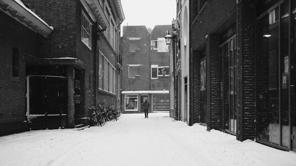 grayscale photo of snow covered road