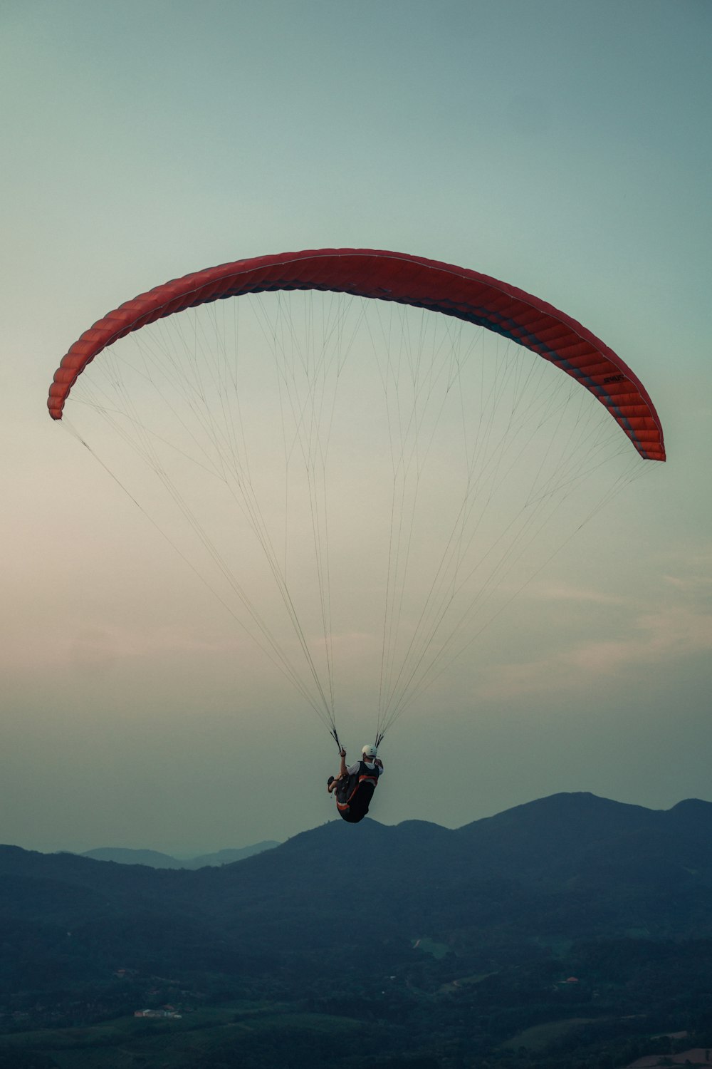 person in red parachute during daytime