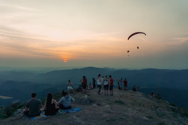 A joyful group of travelers enjoying a scenic sunset together