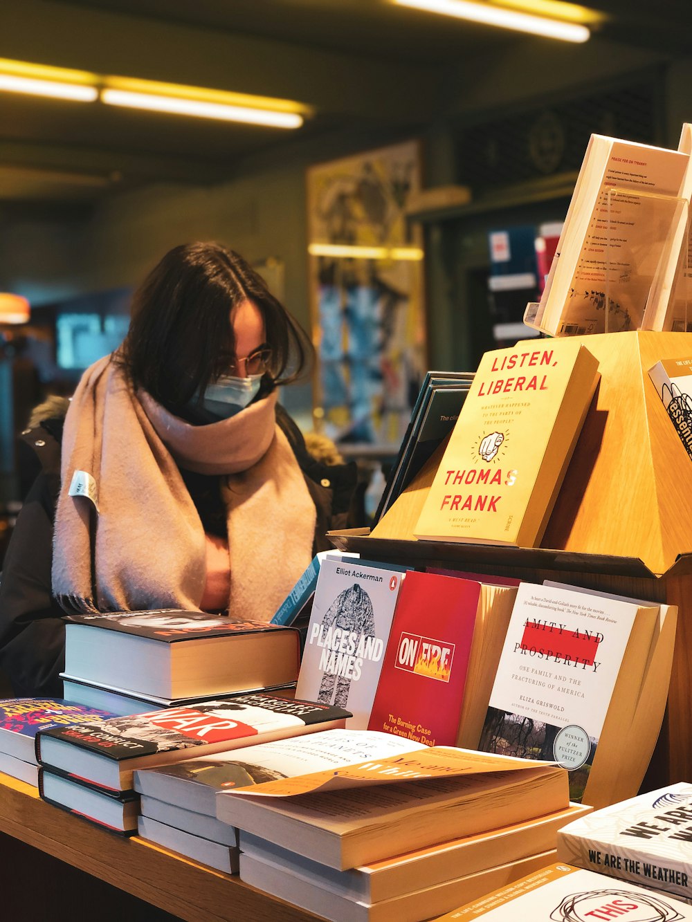 woman in brown scarf and black framed eyeglasses reading book