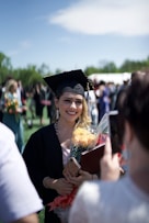 woman in academic dress smiling