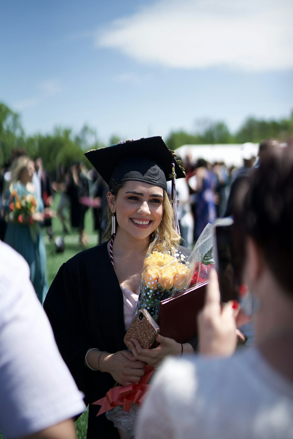 woman in academic dress smiling