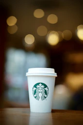 white and green starbucks disposable cup