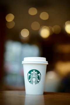 white and green starbucks disposable cup